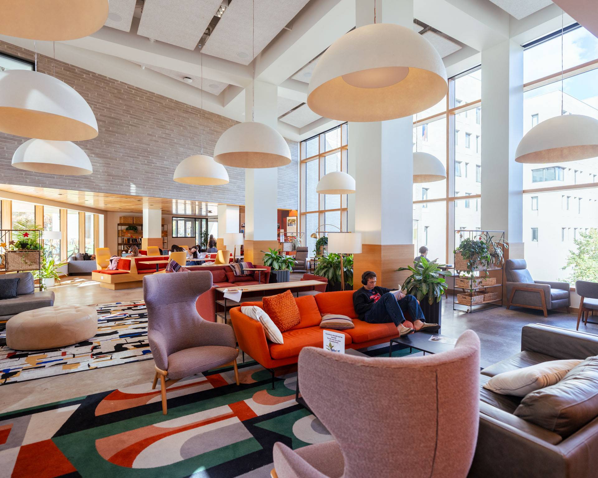 Students study quietly on colorful couches