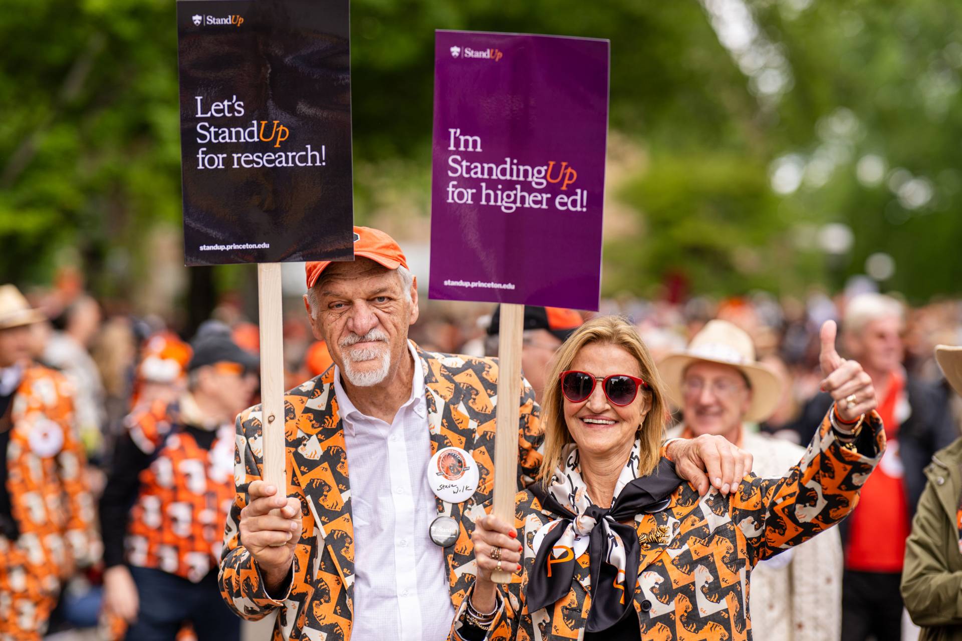 Alumni holding signs in support of the Stand Up for Princeton and Higher Education initiative.