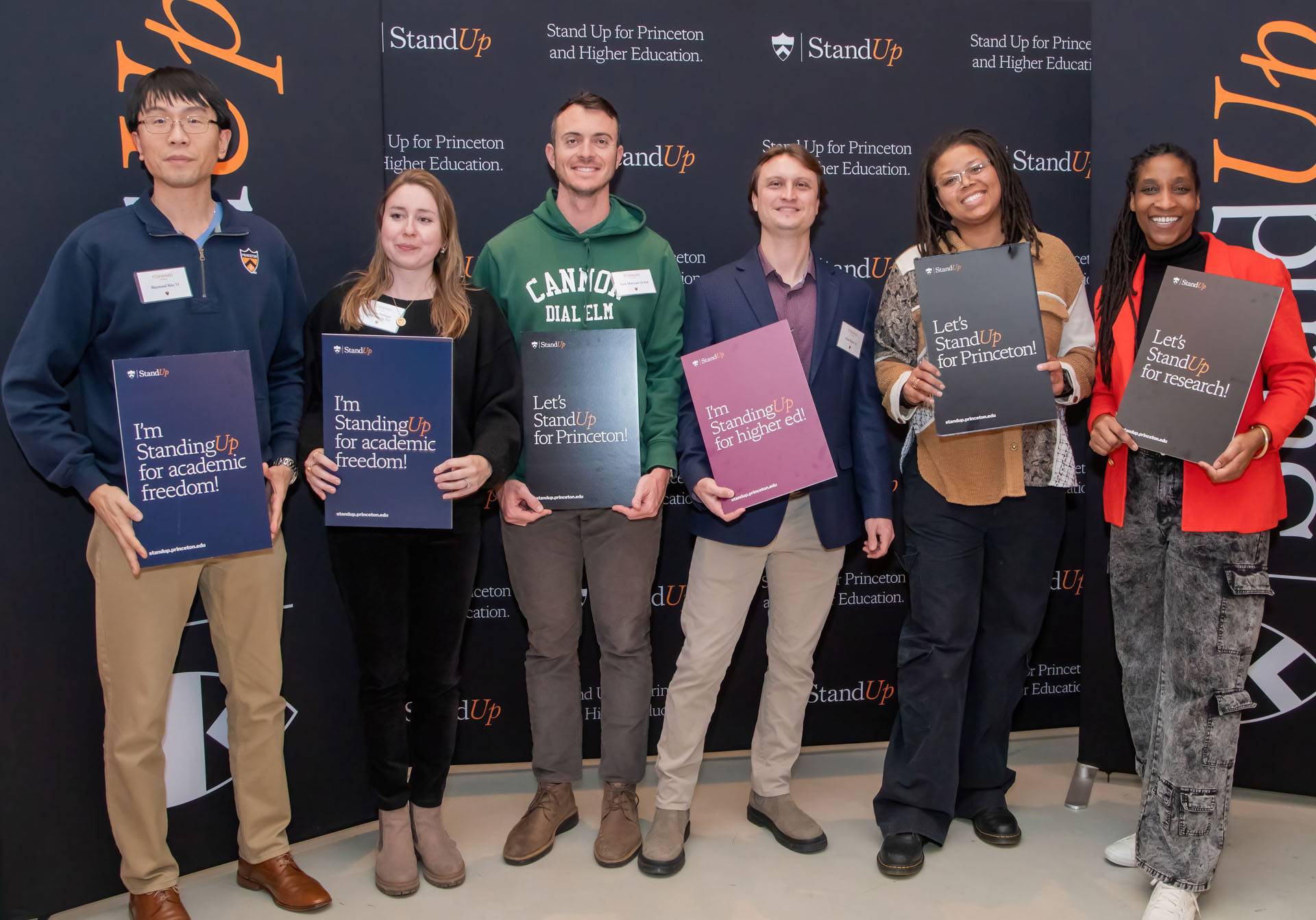 Princeton alumni holding Stand Up signs 
