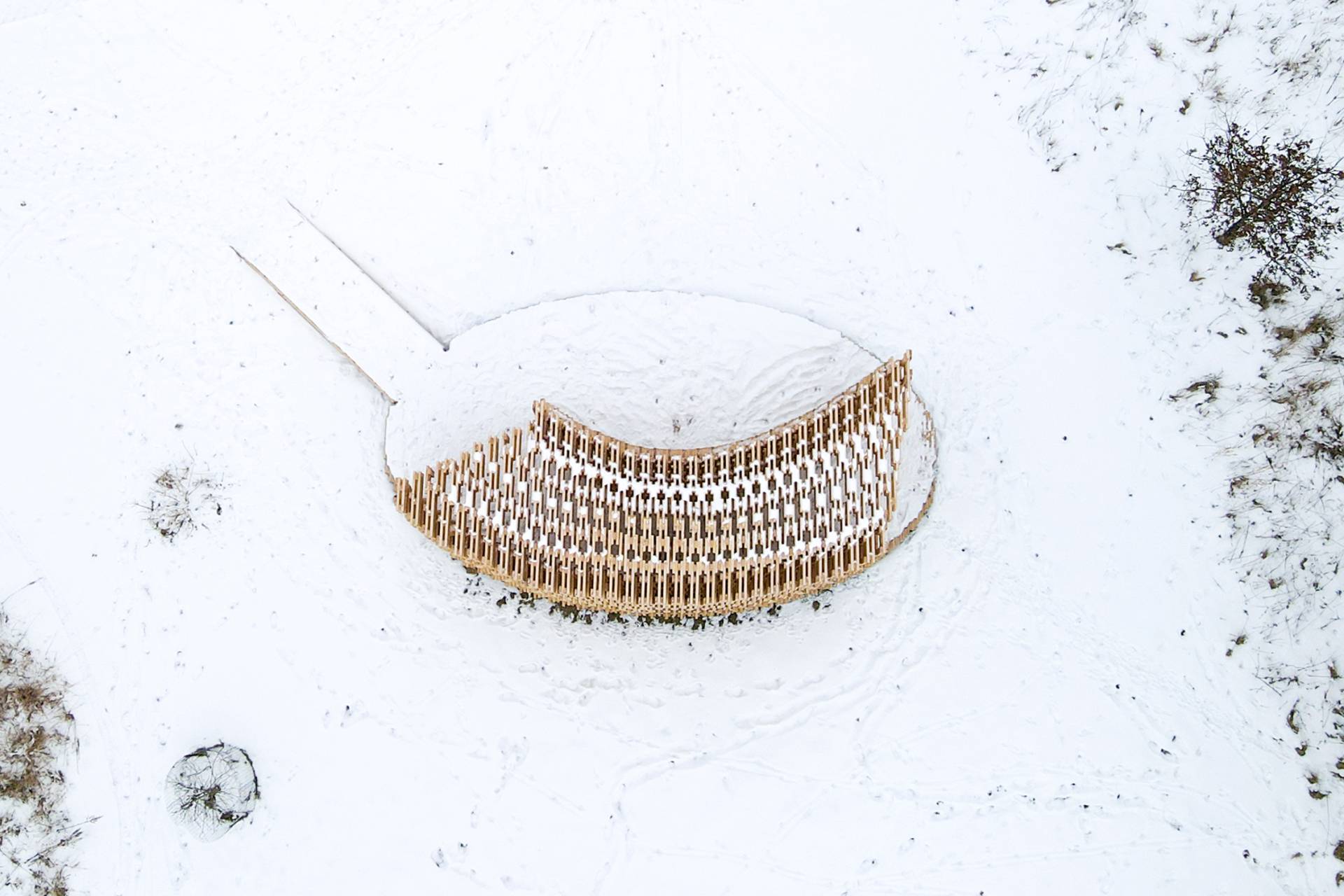 A temporary wooden installation built with human-robot collaboration, pictured in the snow.