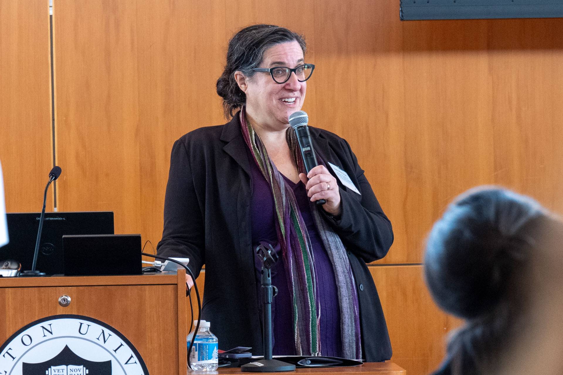 Sarah Schwarz speaks at podium 