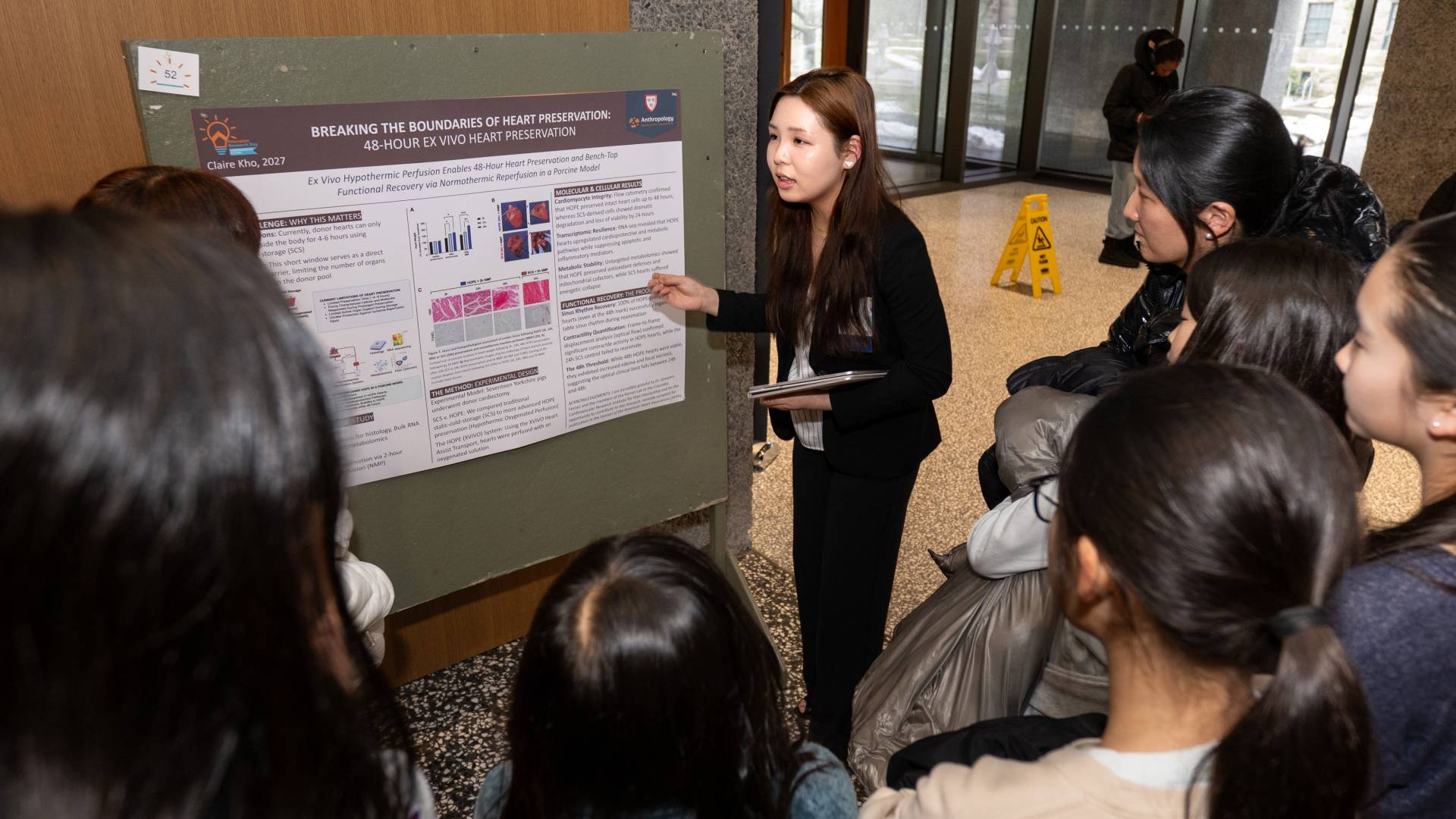 Student presents poster on her heart preservation research to crowd