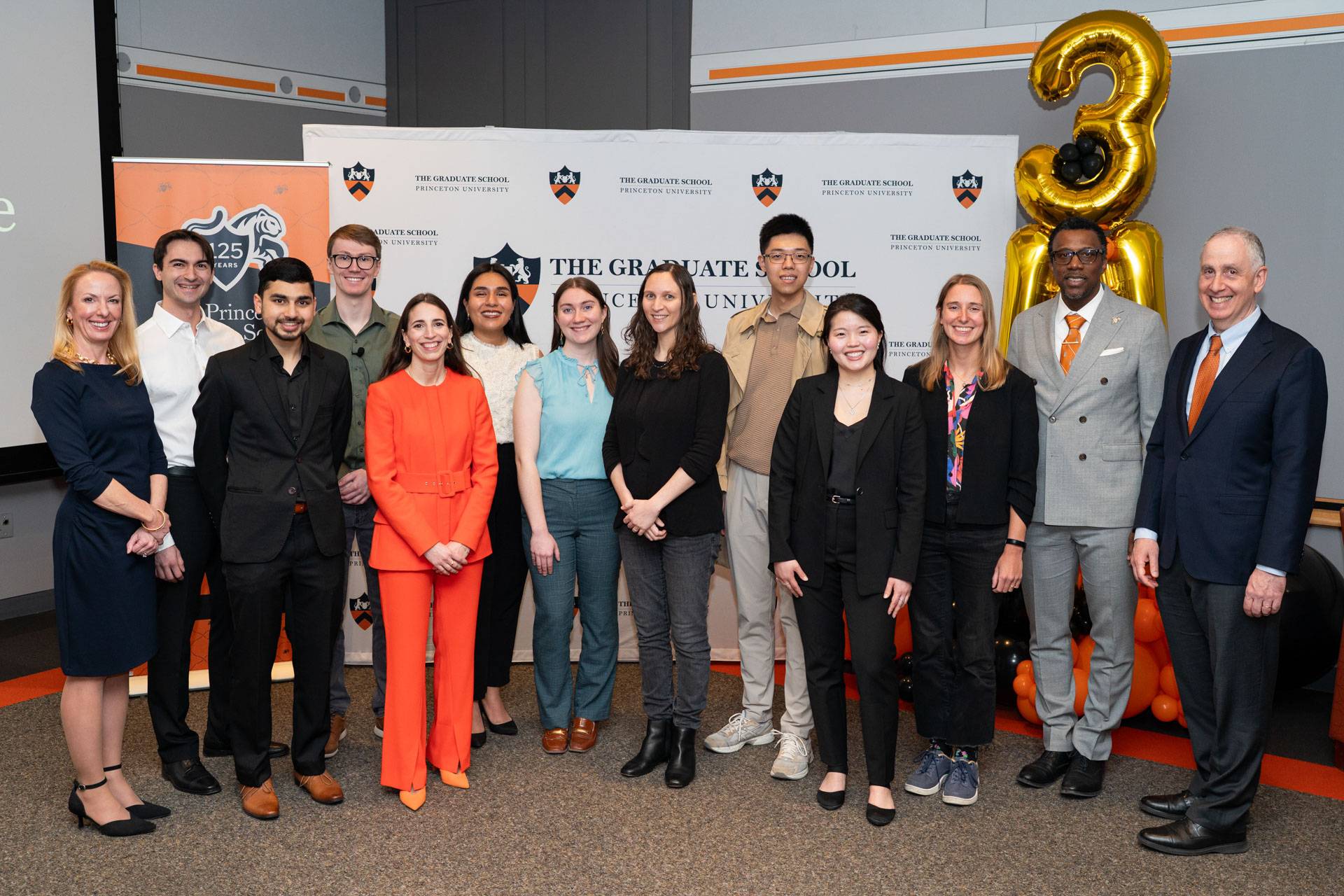 The finalists and judges pose together in front of a Princeton University backdrop.