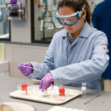Lab worker using vials