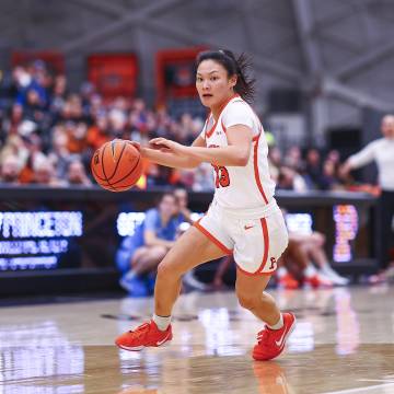 Basketball player Ashley Chea throws a basketball