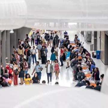 People gather in the lobby of Frick Chemistry Building.