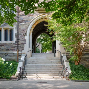 a staircase leading to an arch on campus.