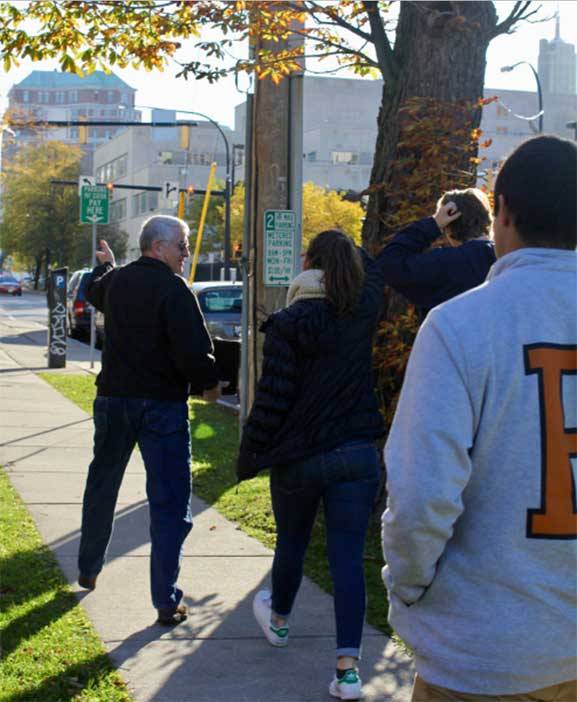 The "Refugee Resettlement: Understanding an Ongoing Journey" trip team got a first-hand look at how refugees have an impact in Buffalo, New York, through a walking tour led by Chuck Massey, a former Houghton College professor involved with refugee resettlement in the city. Here, the team is on the way to Buffalo's City Hall. 