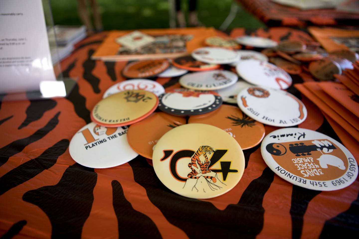 Table with assorted old Reunions buttons