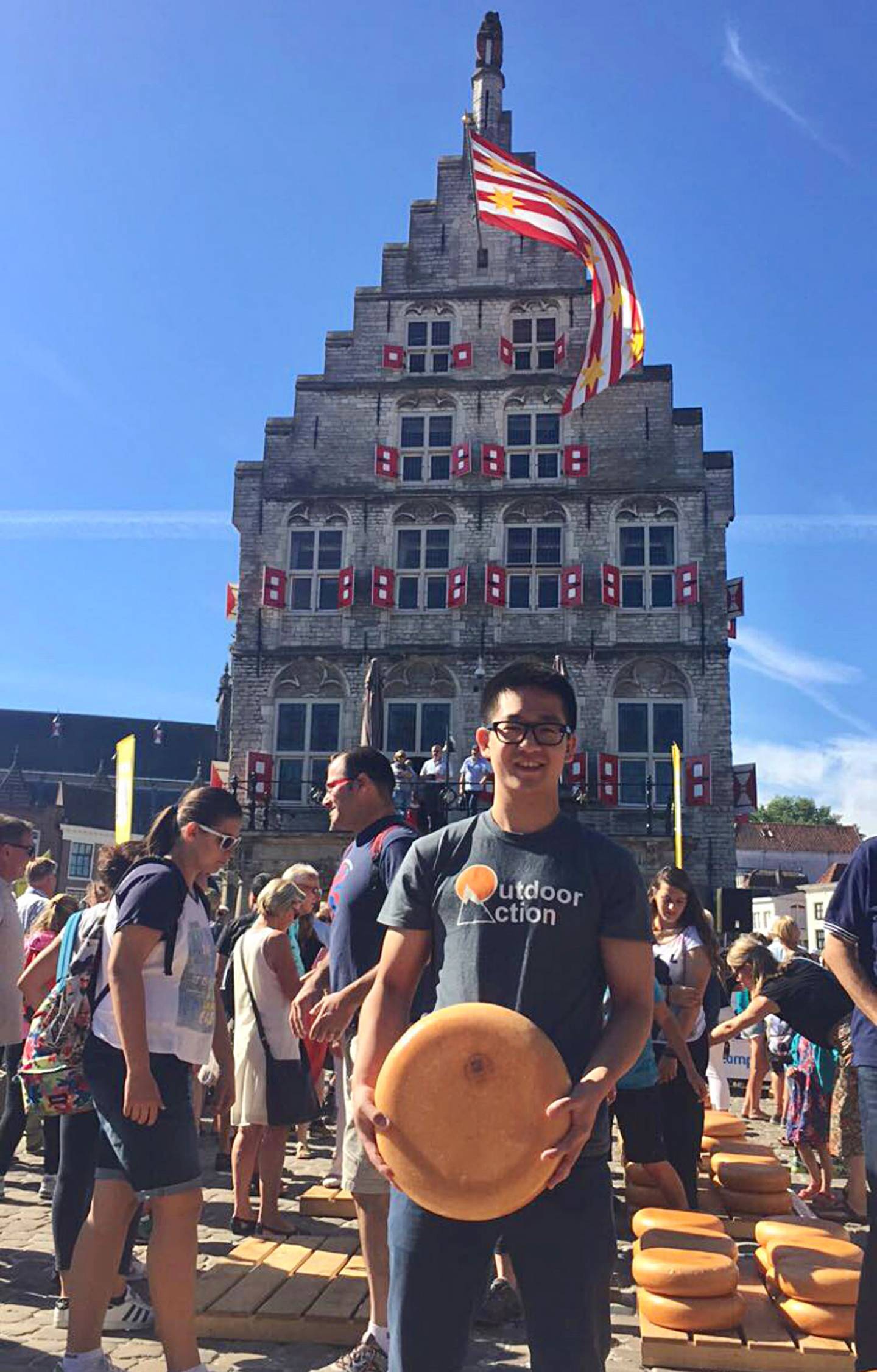 Kim Sha stands with a cheese wheel