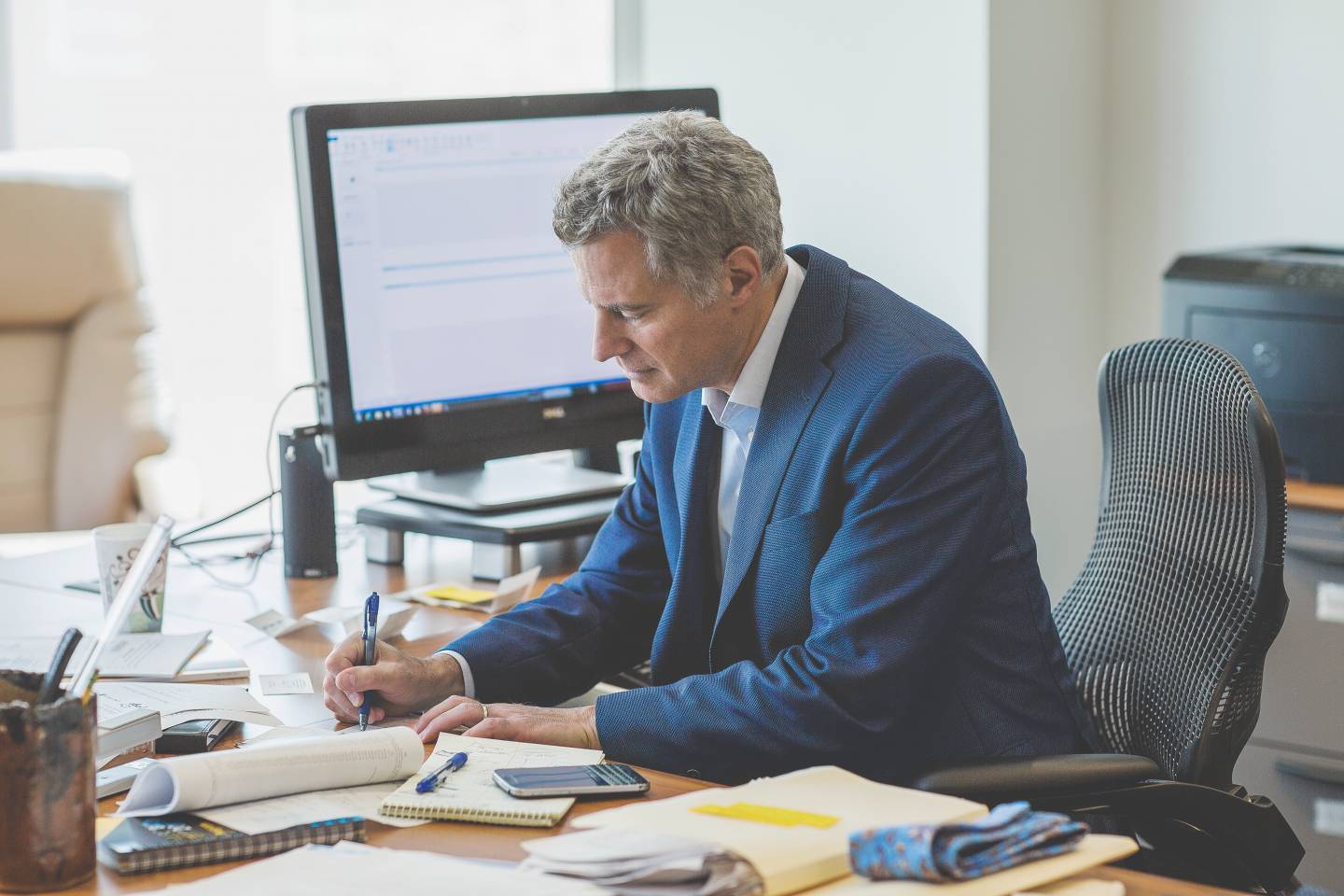 Alan Krueger writing at his desk.