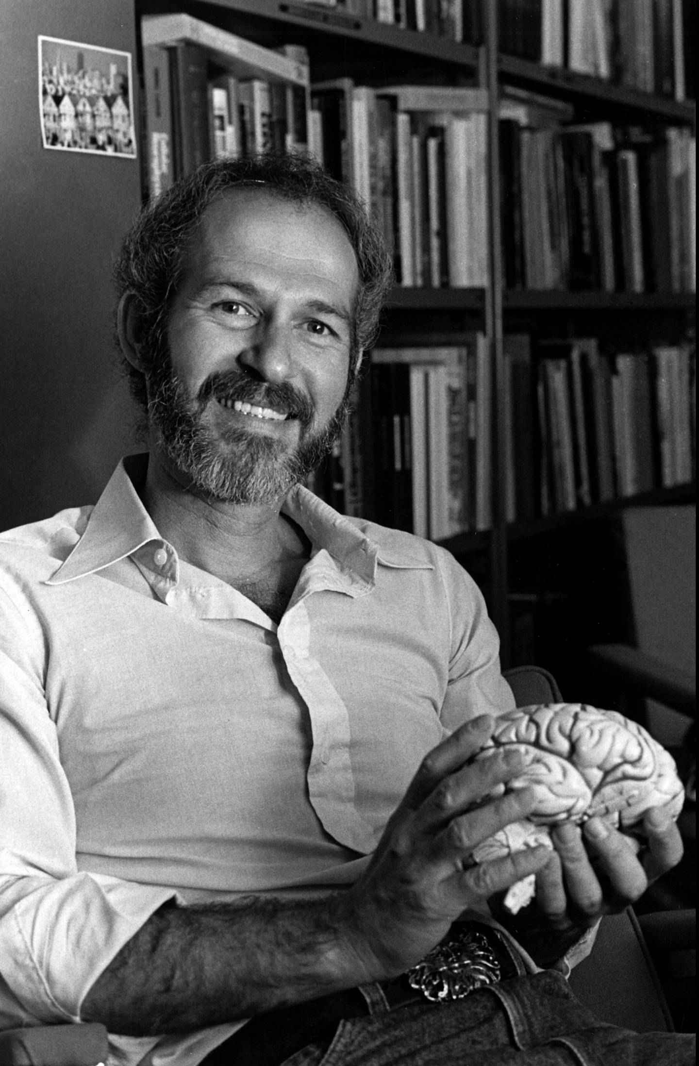 Barry Jacobs holds a model of a human brain