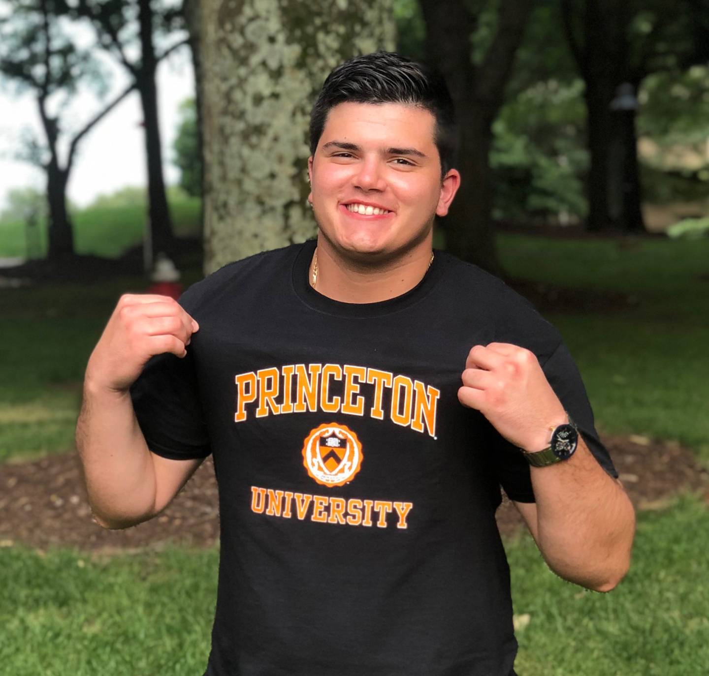 A young man wearing a t-shirt emblazoned with the words "Princeton University"
