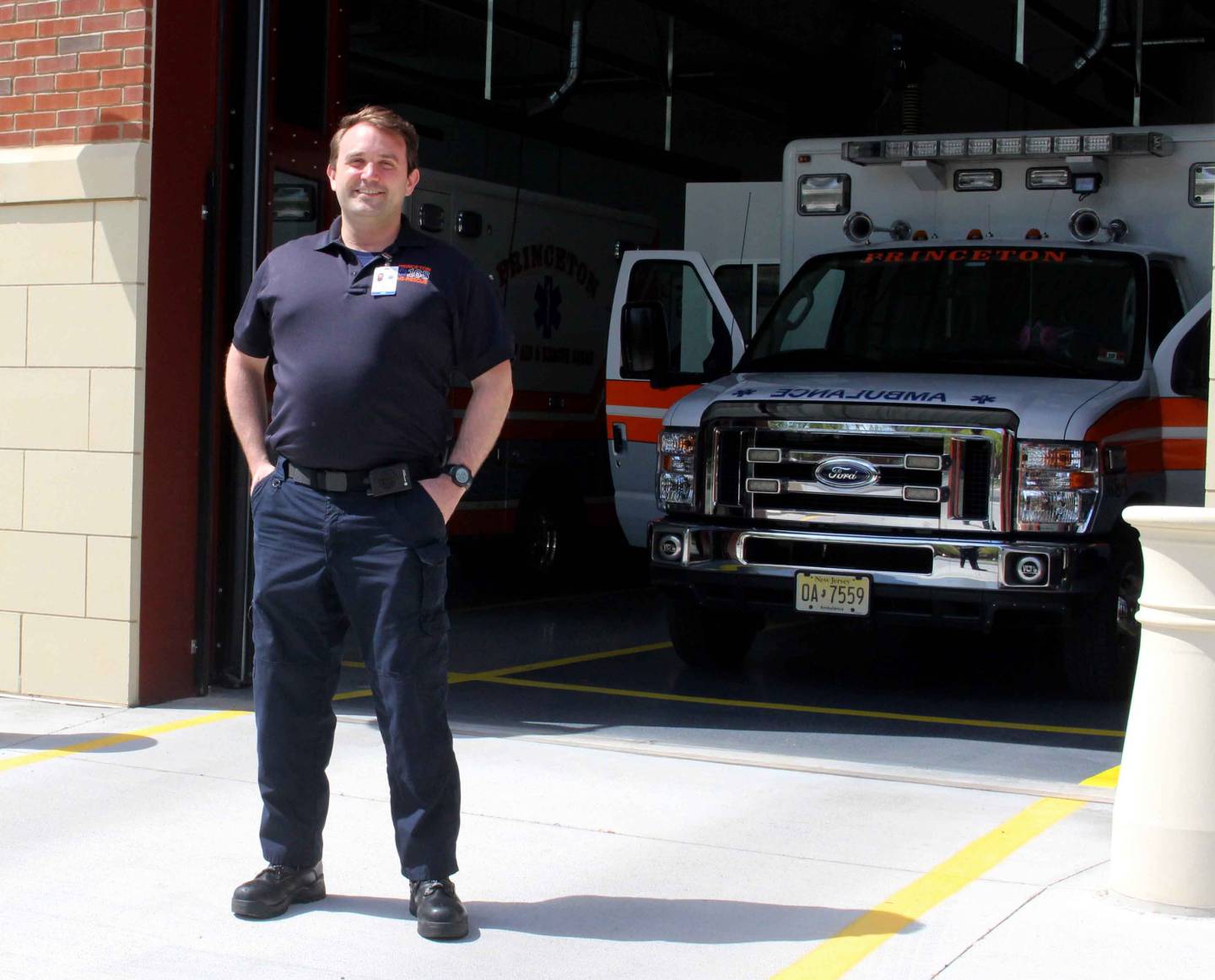 Eric Mills stands in front of an ambulance