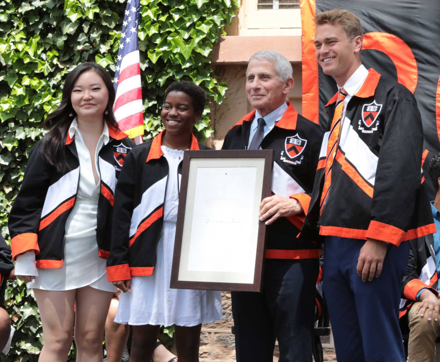 Dr. Fauci poses with members of the Class of 2022 with his honorary class jacket