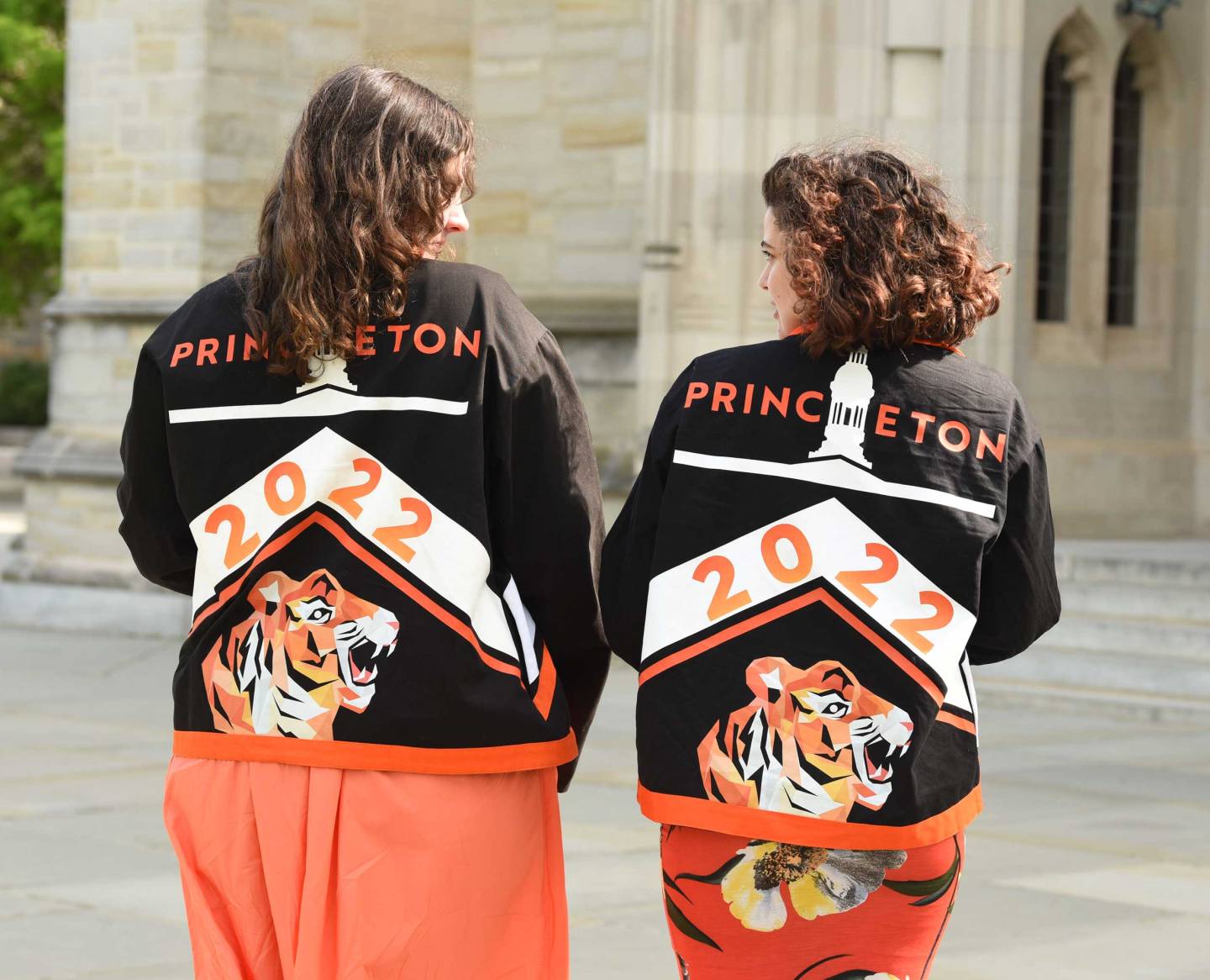 Two students show the backs of their Class Day 2022 jackets