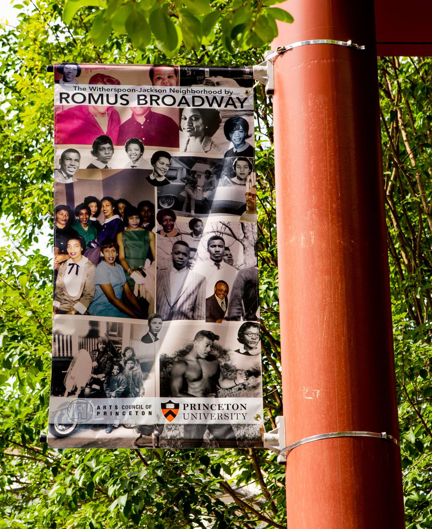 An advertising banner featuring the photographs of Romus Broadway