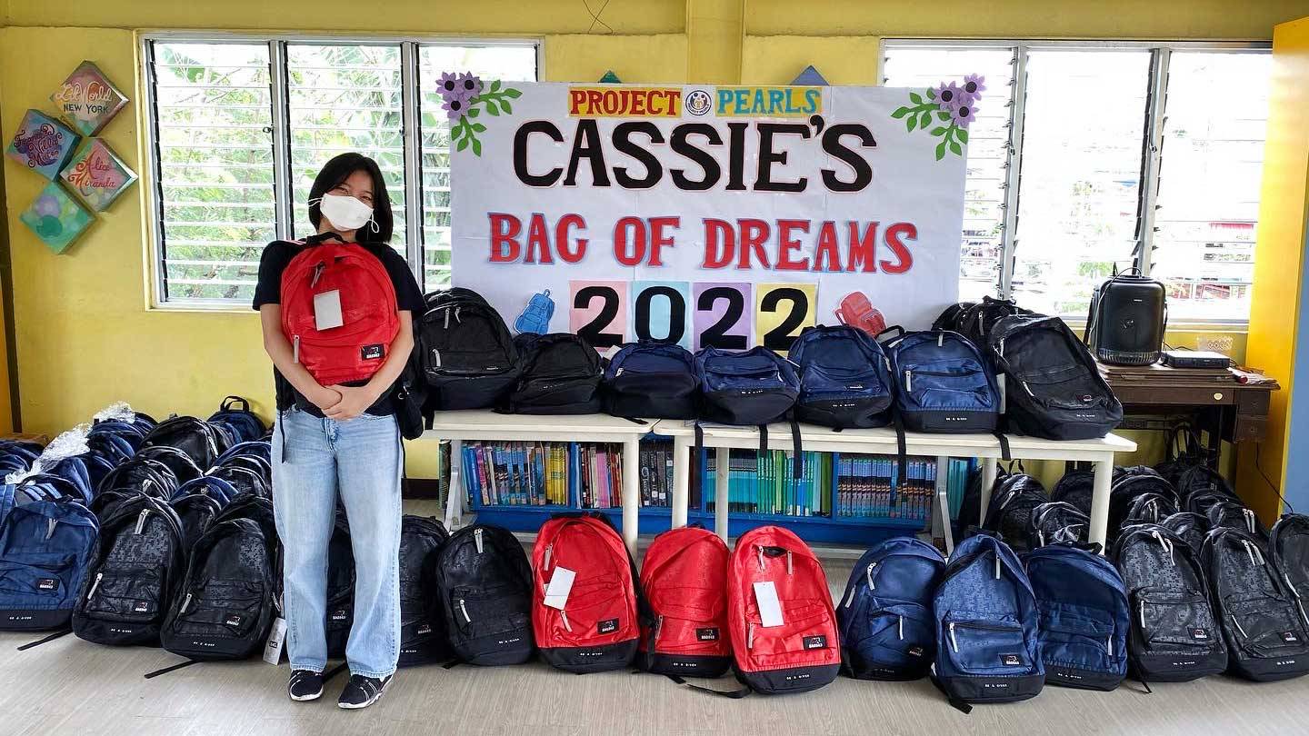 Cassie Eng poses with backpacks