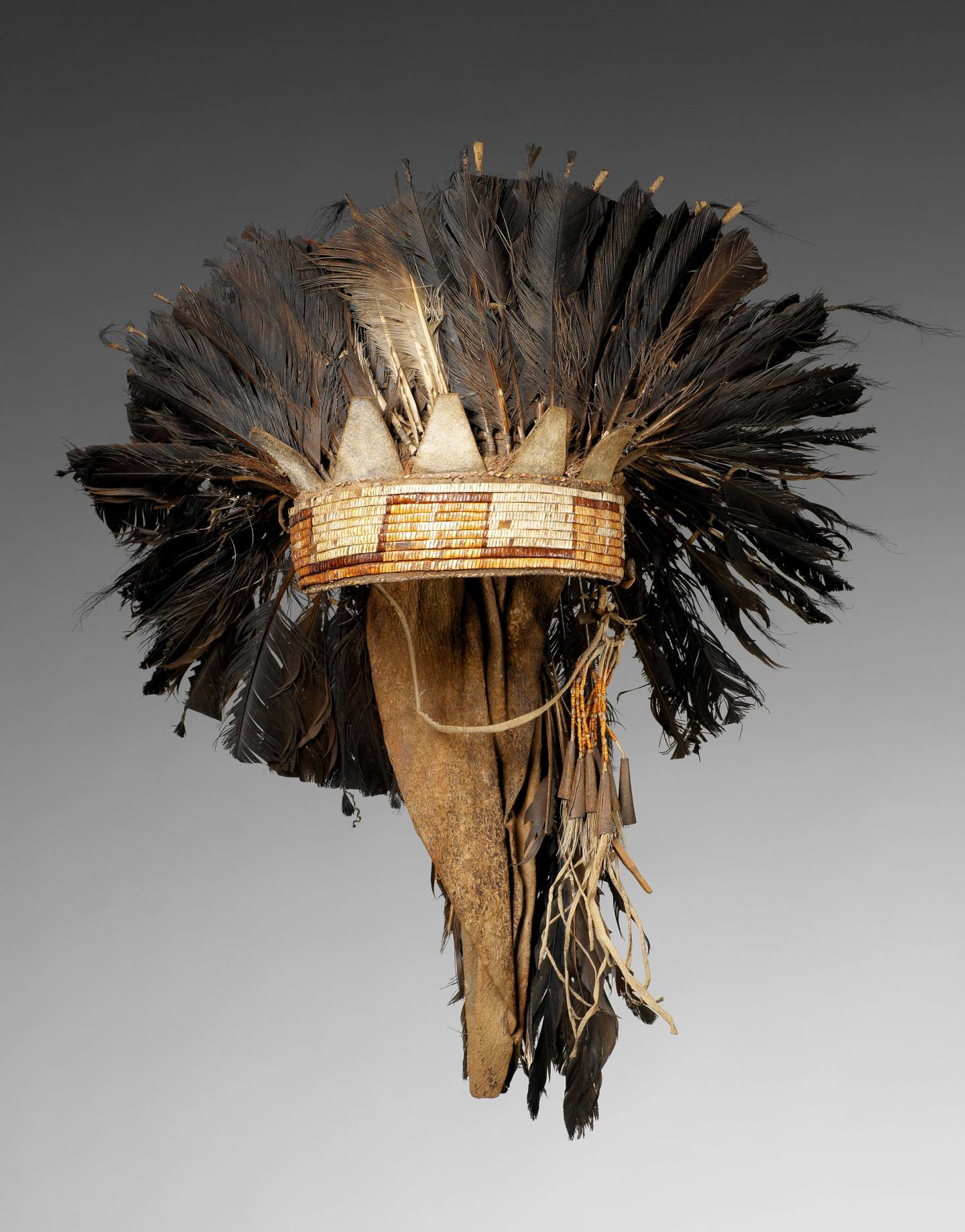A grand headdress and feather bonnet worn by a Native American chief