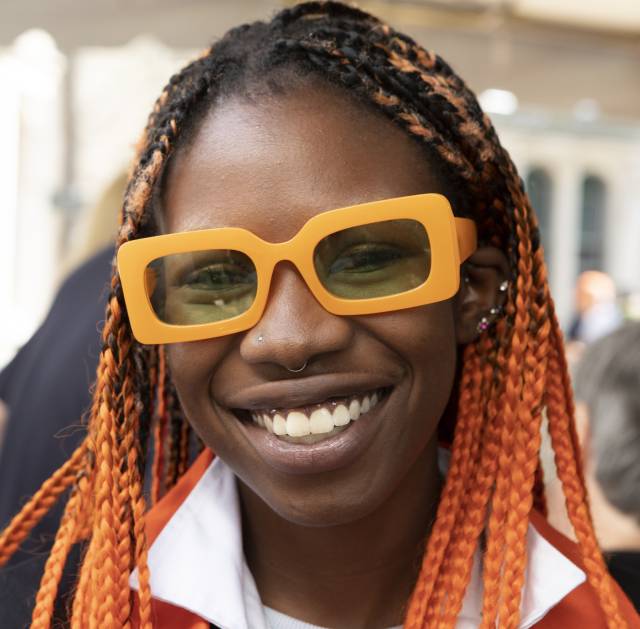 Alumna with orange sunglasses