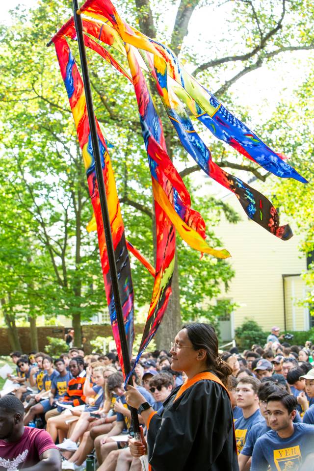 A woman holds a ceremonial kite 