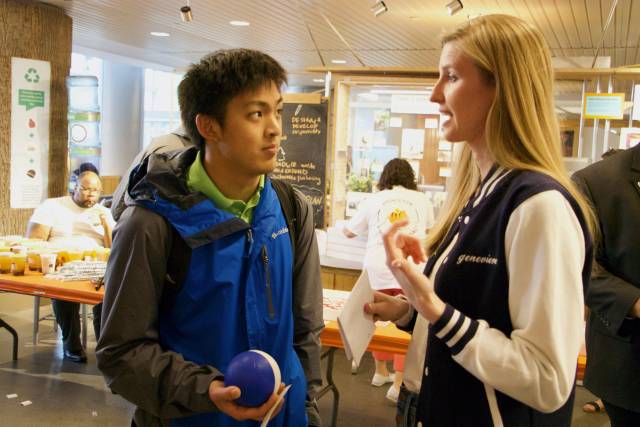 Student talks to an alumna at a financial literacy event.