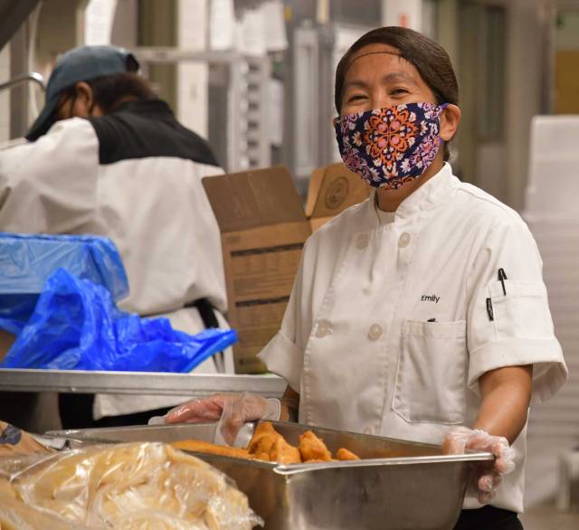 Dining services workers putting together meals