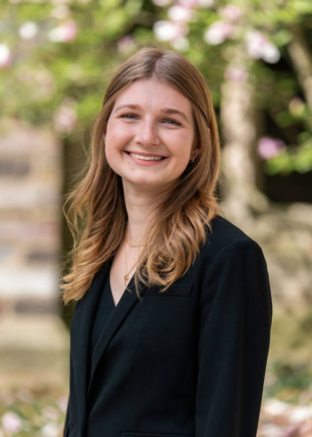 Madeleine Murnick framed by trees on the Princeton campus