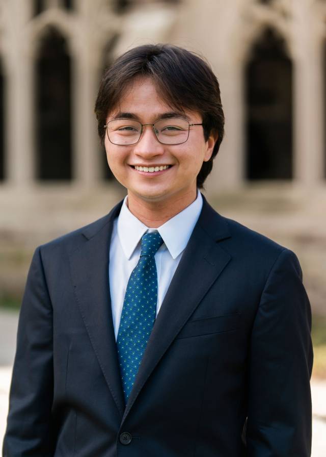 Daniel Yu framed by archways on the Princeton campus