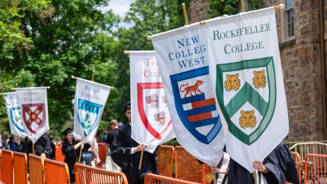 Students parading with gonfalons representing Princeton's Residential Colleges