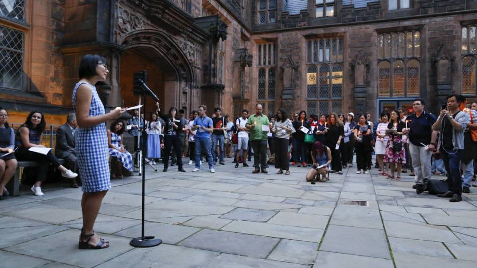 Hua Qu speaks at vigil on campus for her husband, Xiyue Wang.